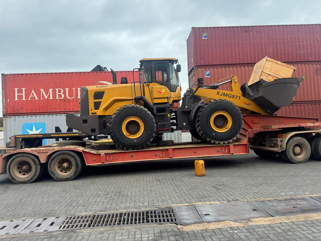 JK Okine payloader XJMG971 loaded on a low-bed trailer at the port