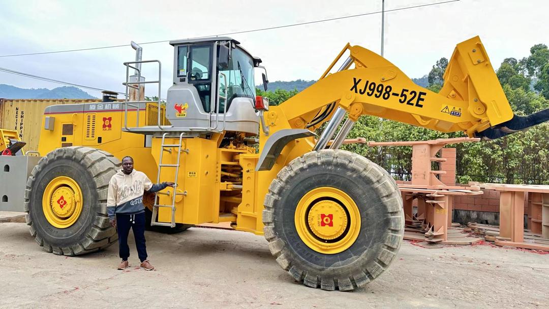 JK Okine large payloader XJ998-52E with person for scale showing machine size
